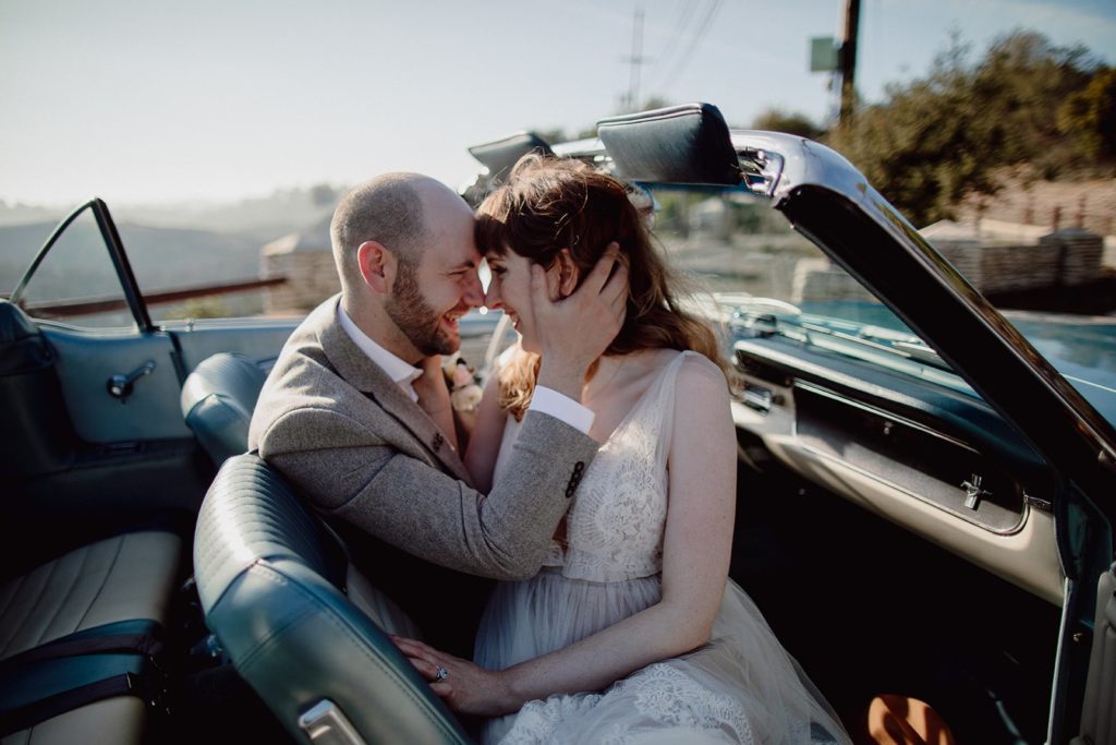 Couple Embracing in a Vintage Car on their Elopement Day in Hollywood
