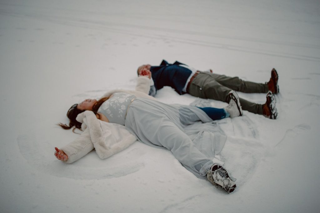 Couple Making Snow Angels on Their elopement in Lake Tahoe California