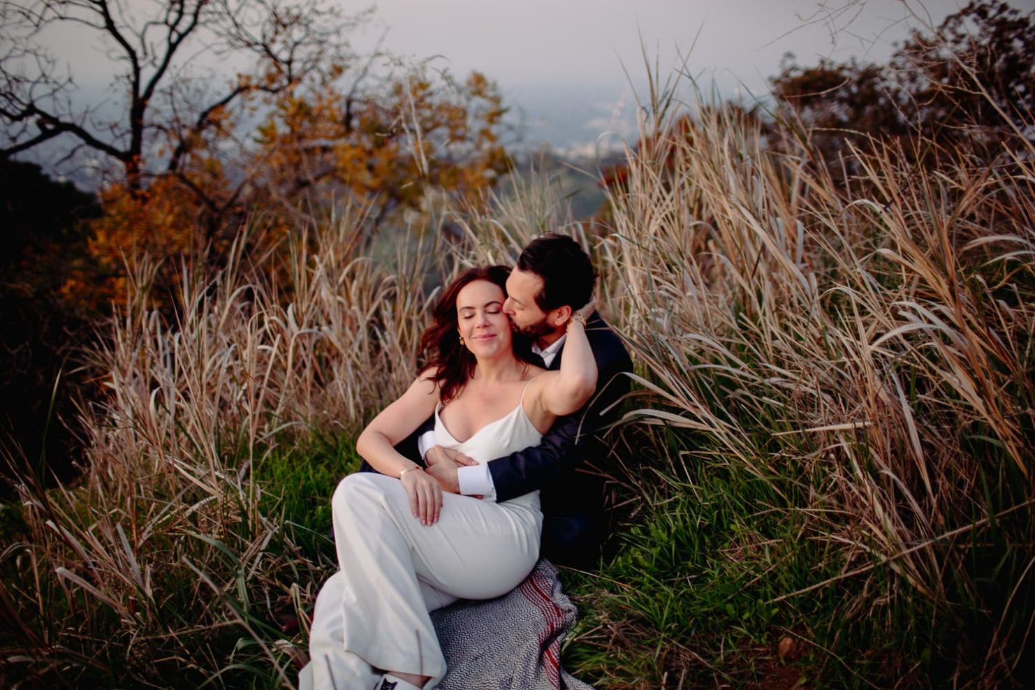 Couple Cudding In the Grass after their elopement Hollywood California