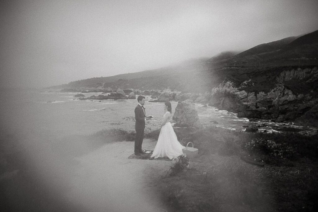 Black and white photo of couple on cliffs of Big Sur California