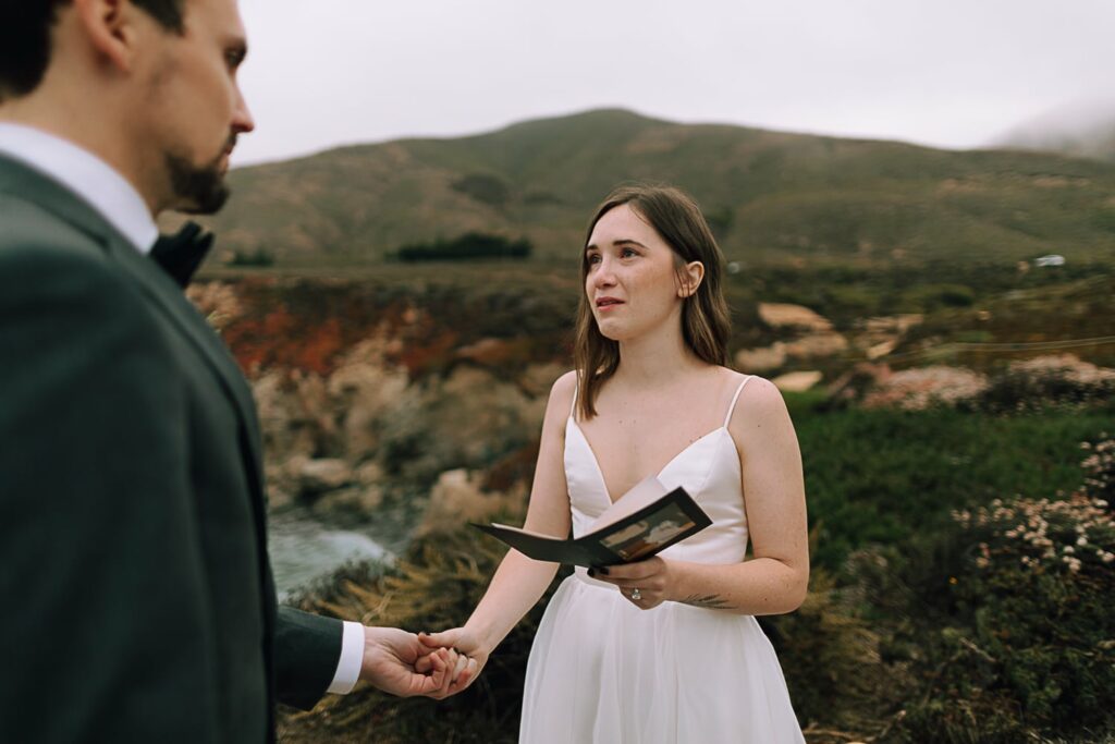 Bride emotionally saying vows at Garrapata State park in Big Sur