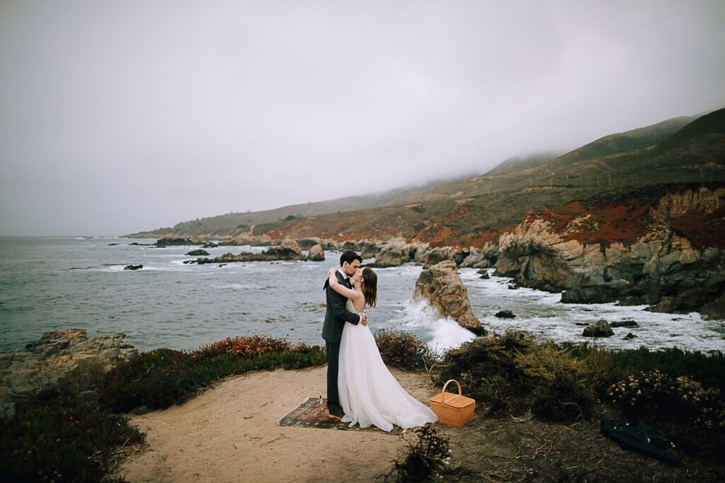 First Kiss of Bride and Groom on Big Sur Cliffs