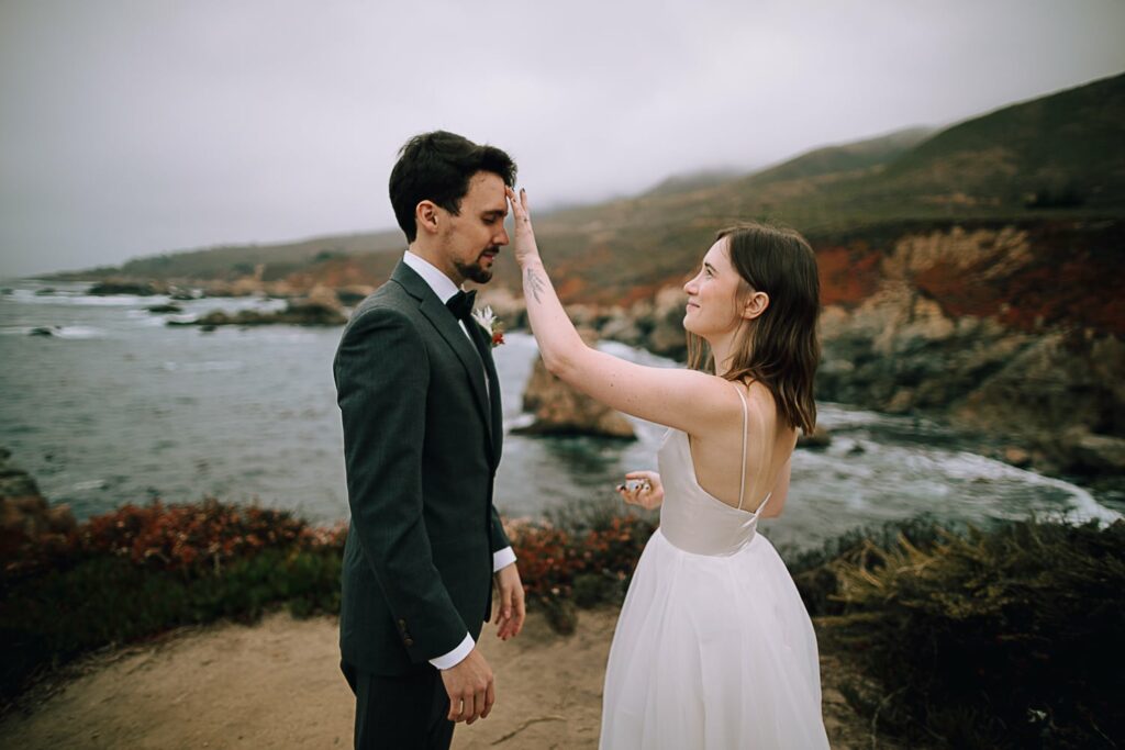 Couple standing on cliffs during Big Sur wedding ceremony