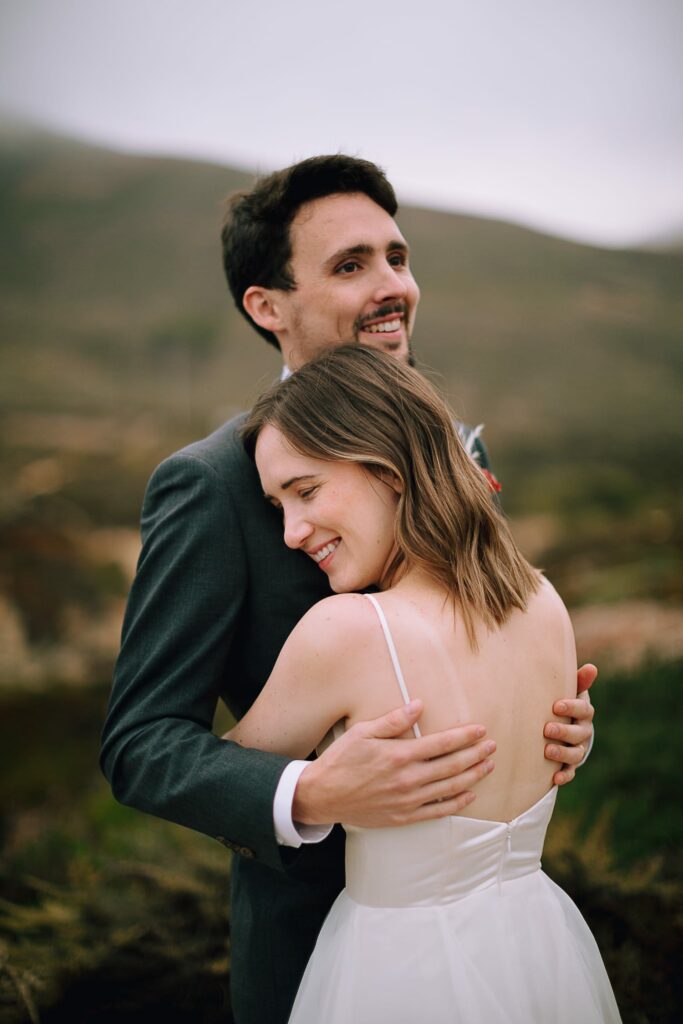 Couple hugging on wedding day in Big Sur