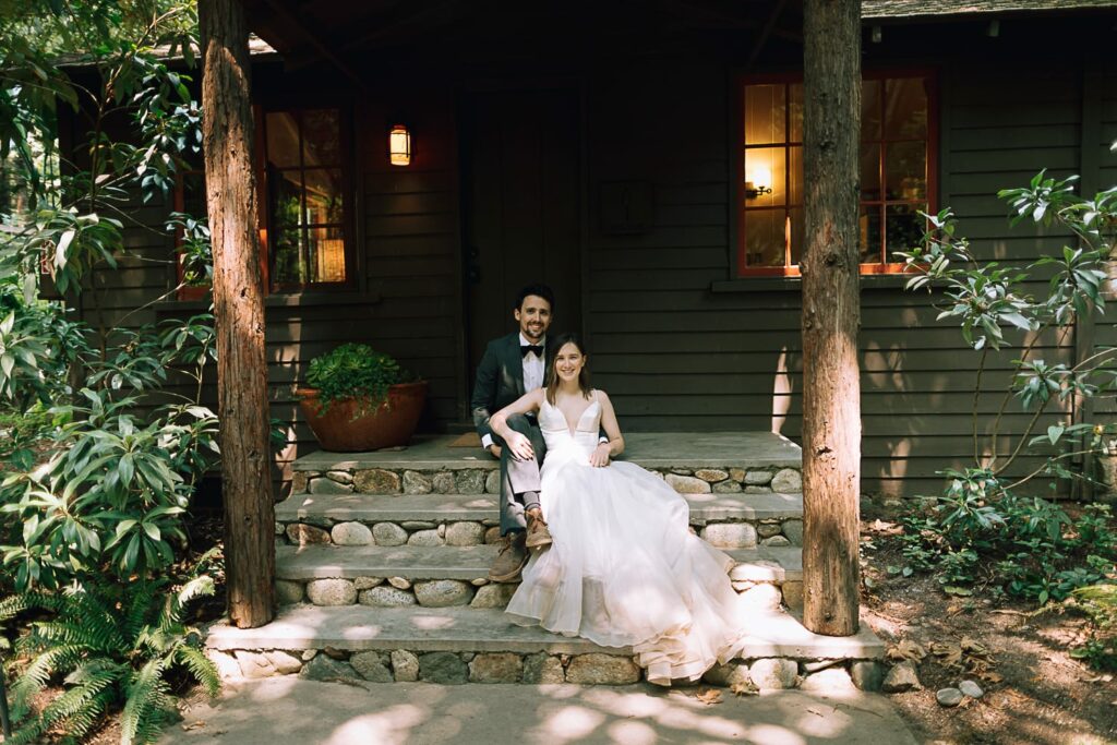 Couple sitting on the porch of their Glen Oaks Big Sur Cabin on their wedding day